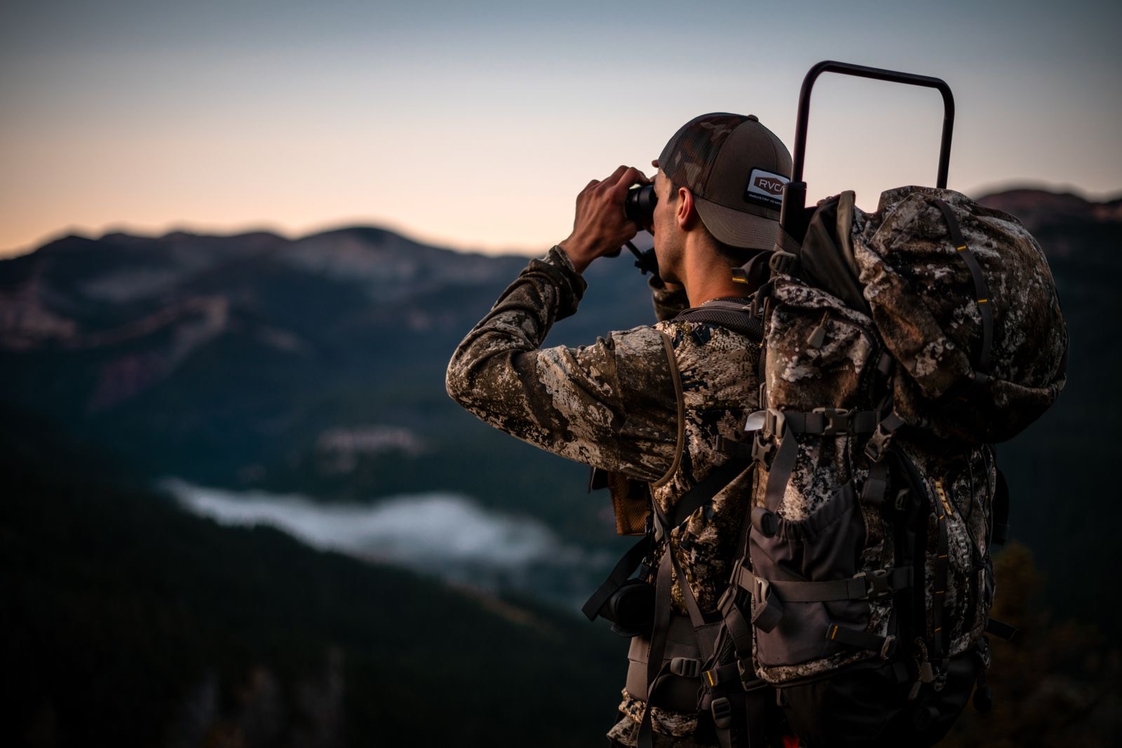 Hunter glassing a ridge at dusk